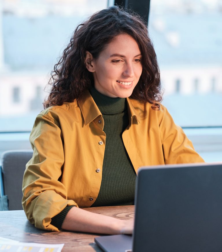 Businesswoman using laptop at office