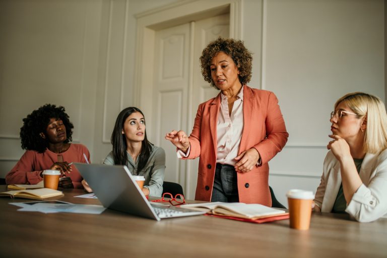 Senior manager leading a business meeting with her team in the office