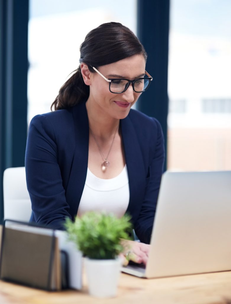 Shot of a busy businesswoman working on her laptop in her office